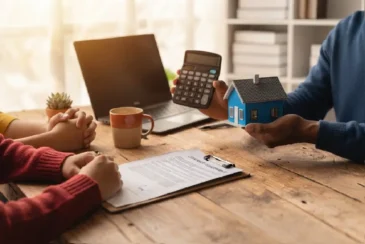 Financial advisor explaining mortgage refinancing for debt consolidation options to a couple during a home loan consultation