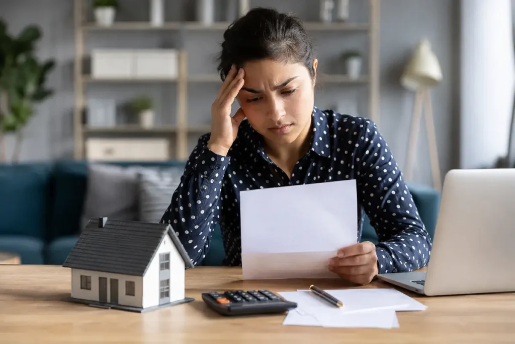 Woman reviewing a rejected mortgage application document