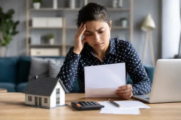Woman reviewing a rejected mortgage application document